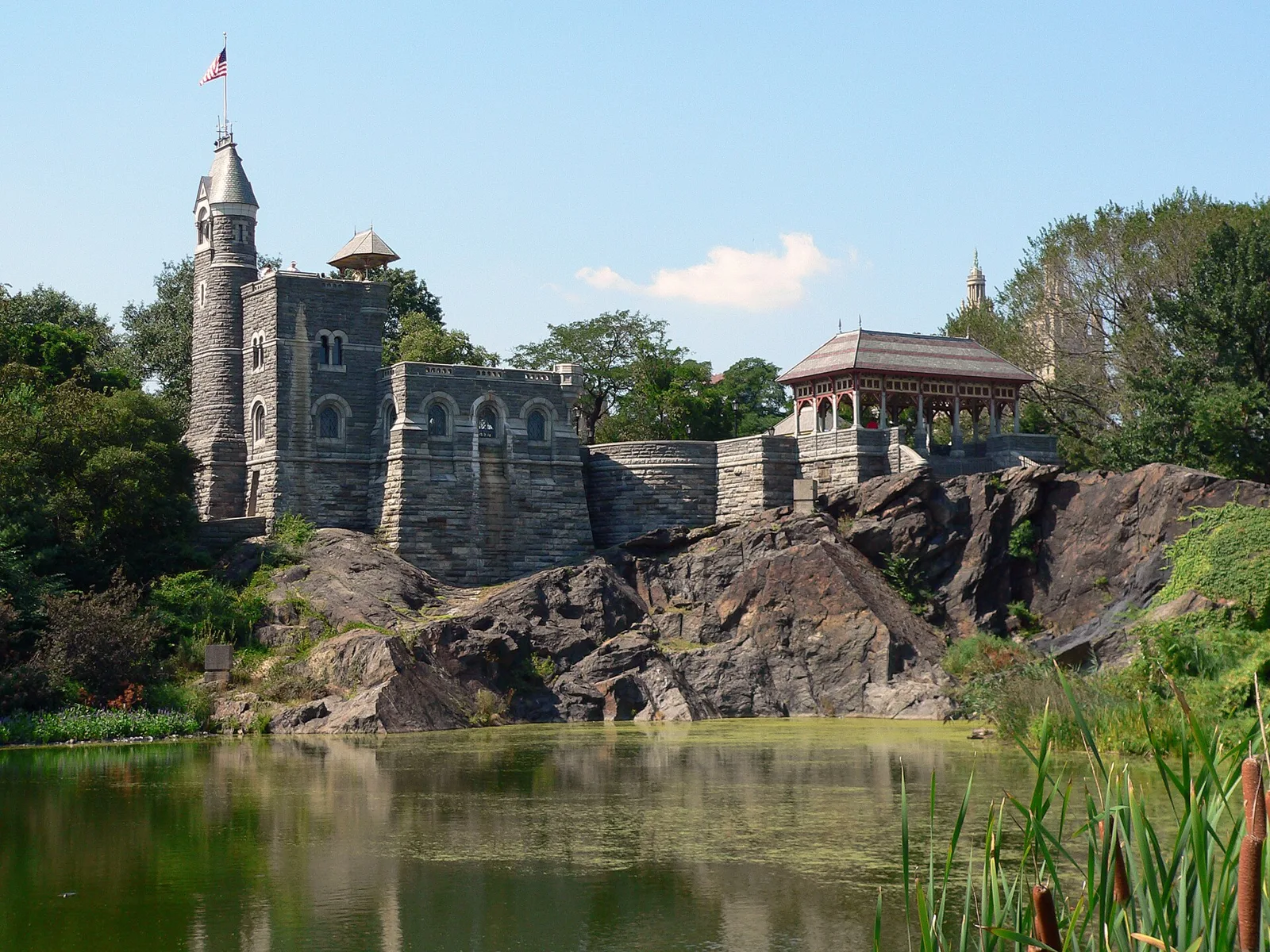 Belvedere Castle on its rocky outcrop above a pond in Central Park on a clear day