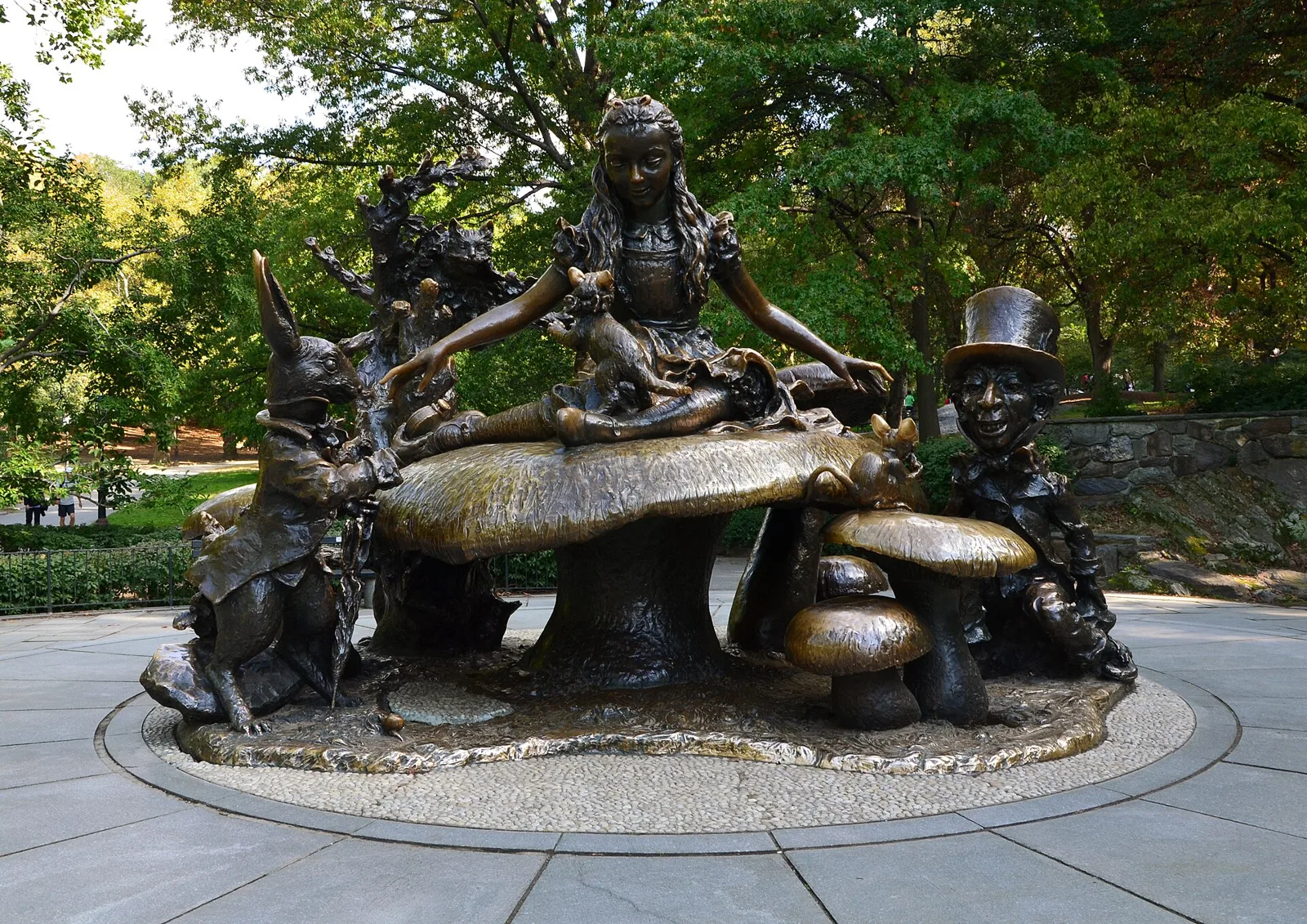 The bronze Alice in Wonderland statue in Central Park, with Alice seated on a giant mushroom beside the White Rabbit and the Mad Hatter