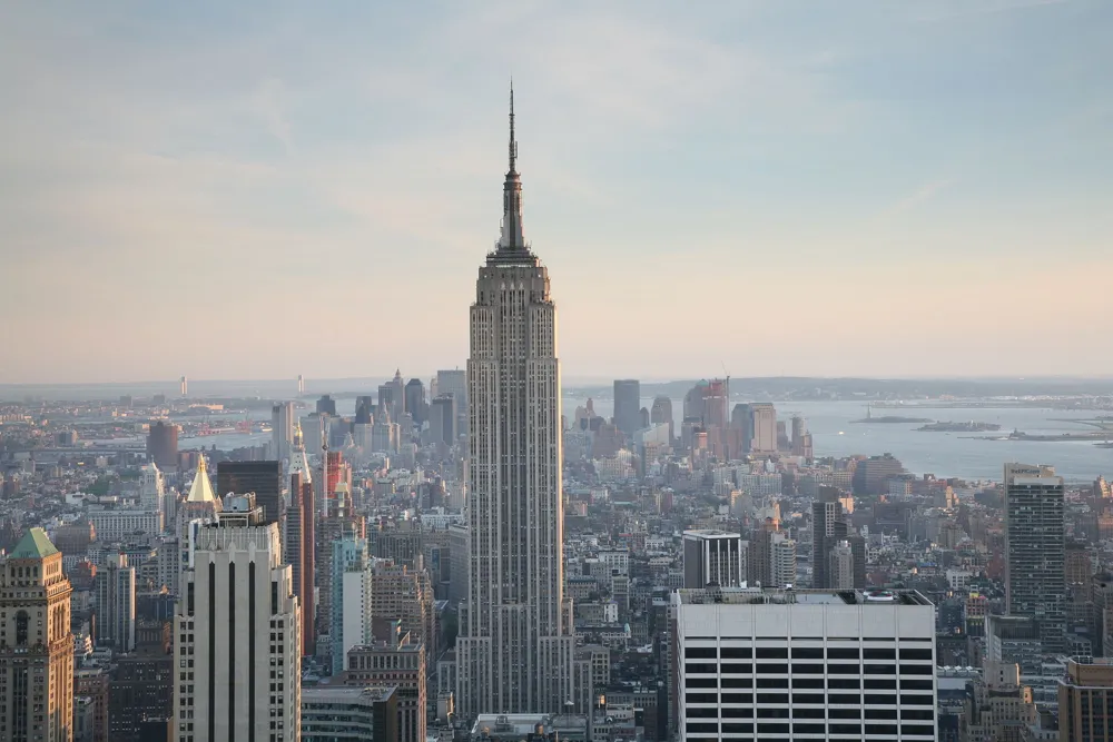 Aerial view of the Empire State Building above Midtown Manhattan in soft evening light
