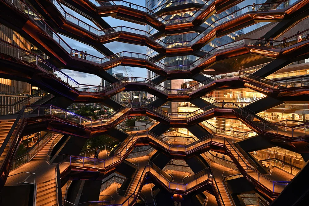 The Vessel at Hudson Yards, a climbable structure of copper-colored stairways, seen from below.