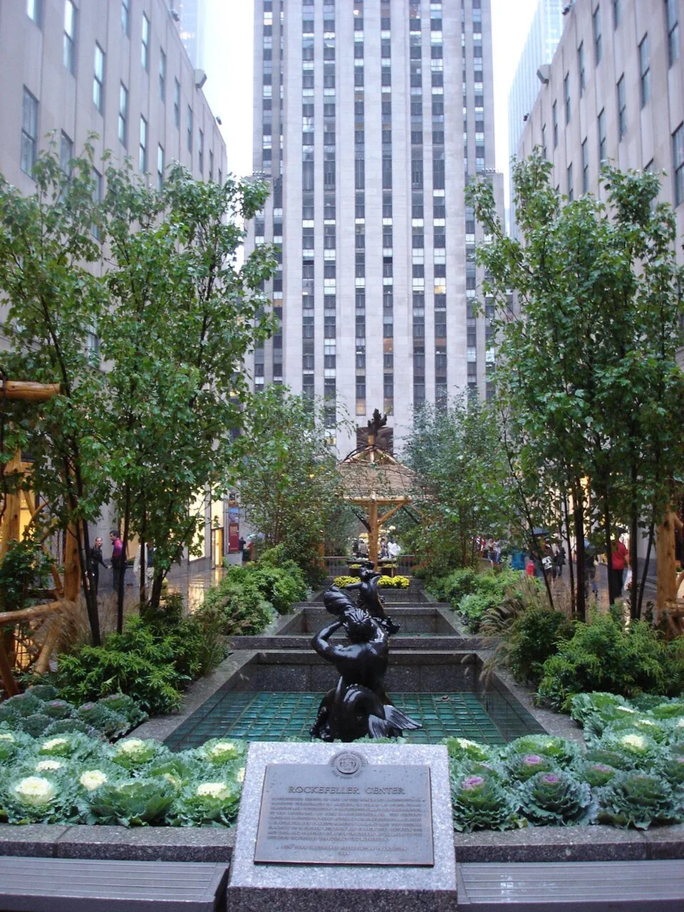 The Channel Gardens at Rockefeller Center, with a fountain and planted beds leading to the tower beyond